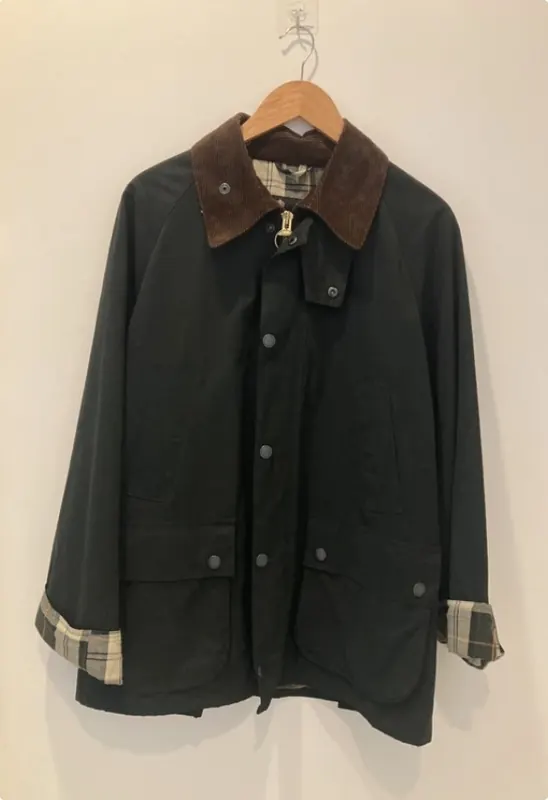 Veste Barbour huilée vert foncé à col en velours marron, sur cintre